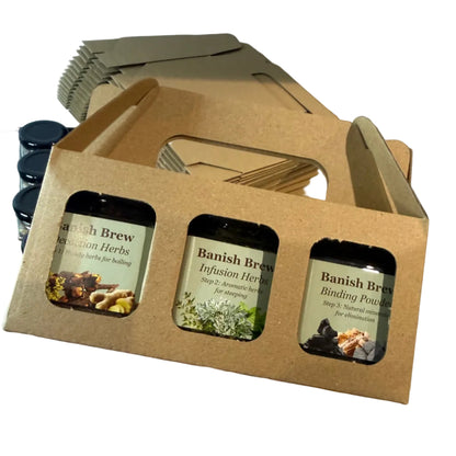 Hand holding a cardboard packaging with three small containers labeled 'Banish Brew'.